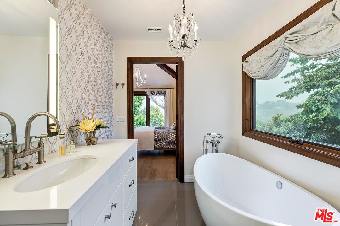 13146 Rivers Road Los Angeles, CA 90049 - Photo 15 of 38 a bathroom with a double vanity sink and a bathtub