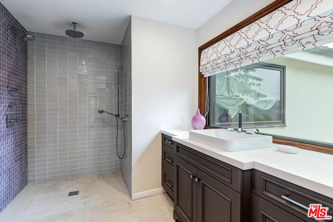 13146 Rivers Road Los Angeles, CA 90049 - Photo 18 of 38 a bathroom with a sink and a mirror