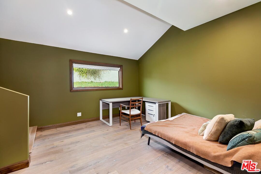 13146 Rivers Road Los Angeles, CA 90049 - Photo 19 of 38 a bedroom with a bed and a table