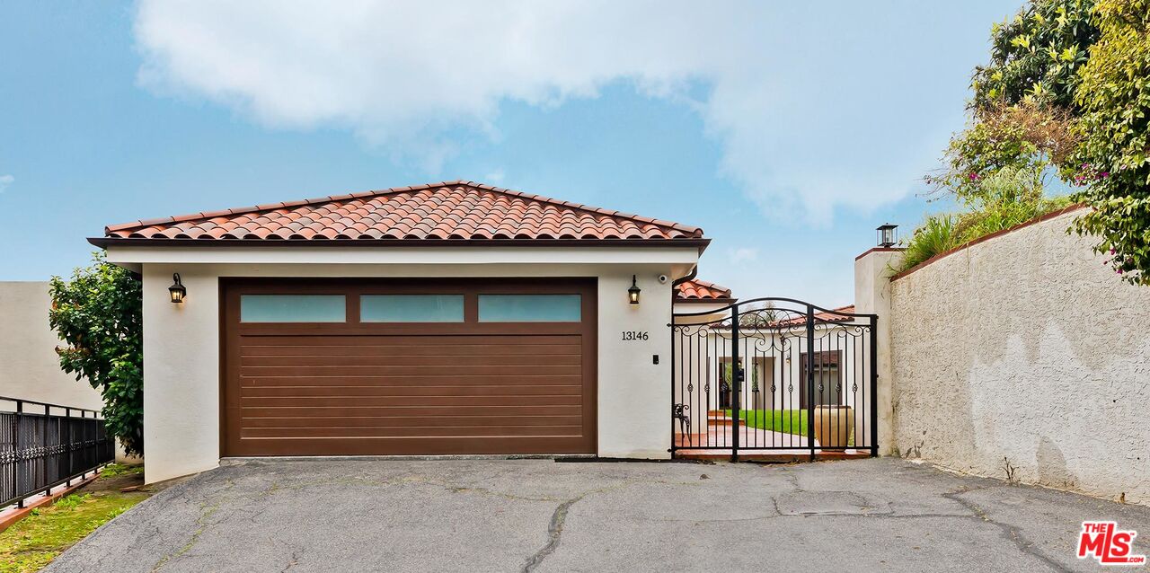 13146 Rivers Road Los Angeles, CA 90049 - Photo 3 of 38 a view of a house with a garage