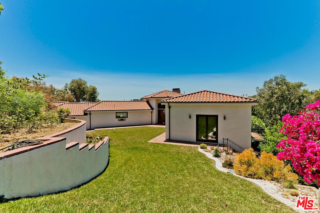 13146 Rivers Road Los Angeles, CA 90049 - Photo 33 of 38 a view of a house with a swimming pool