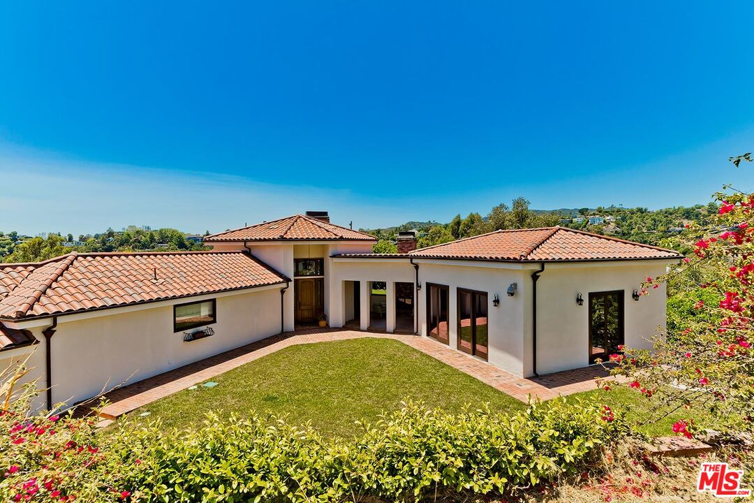 13146 Rivers Road Los Angeles, CA 90049 - Photo 34 of 38 a view of a house with a garden
