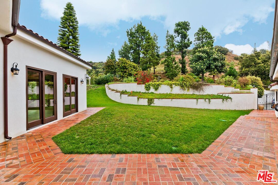 13146 Rivers Road Los Angeles, CA 90049 - Photo 5 of 38 a view of a backyard with large trees