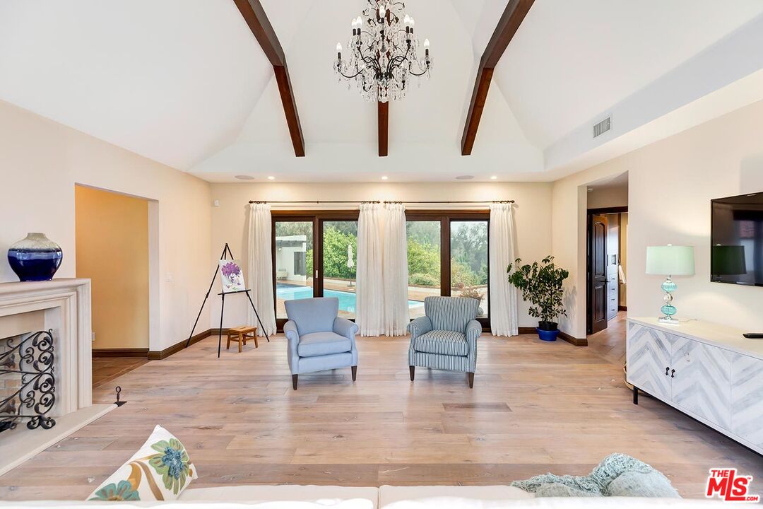 13146 Rivers Road Los Angeles, CA 90049 - Photo 9 of 38 a living room with furniture and a chandelier