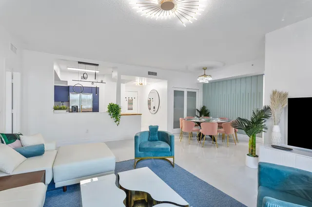 a living room with furniture potted plant and a window