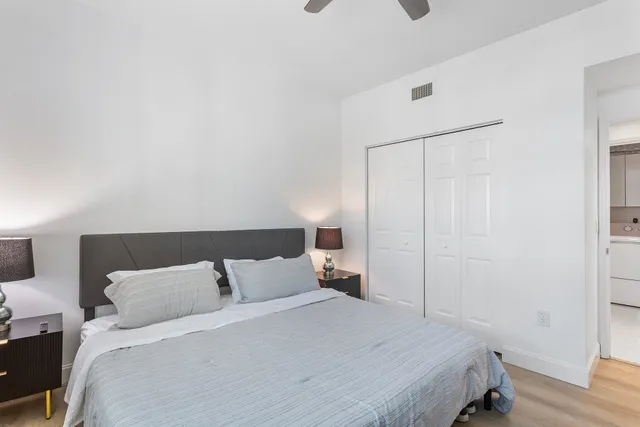 a bedroom with a bed and wooden floor