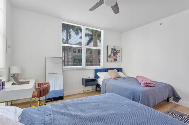 a bedroom with two beds and a window