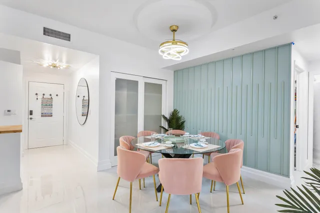 a view of a dining room with furniture and chandelier