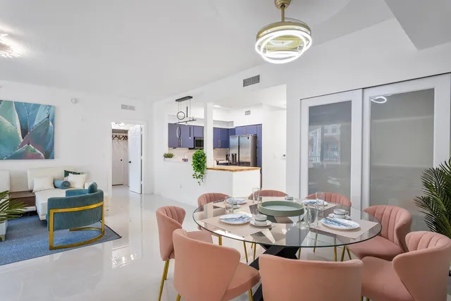 a view of a dining room with furniture and chandelier