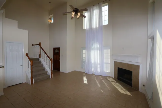 a view of an empty room with a fireplace