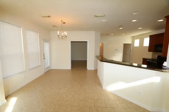 a view of a kitchen with a sink and a large mirror