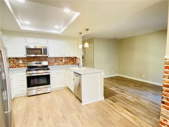 a kitchen with stainless steel appliances a stove top oven and sink