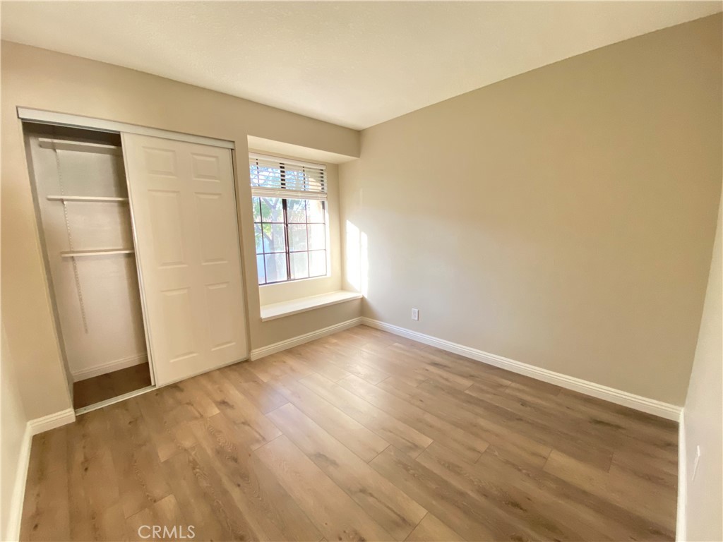 30 Mountain Shadows Place Pomona, CA 91766 - Photo 13 of 23 an empty room with wooden floor and windows