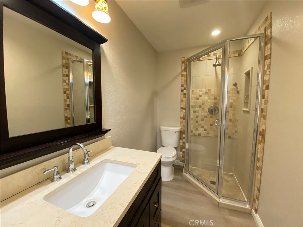 30 Mountain Shadows Place Pomona, CA 91766 - Photo 17 of 23 a bathroom with a shower sink and mirror