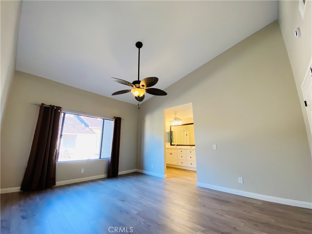 30 Mountain Shadows Place Pomona, CA 91766 - Photo 19 of 23 a view of an empty room with a window and wooden floor