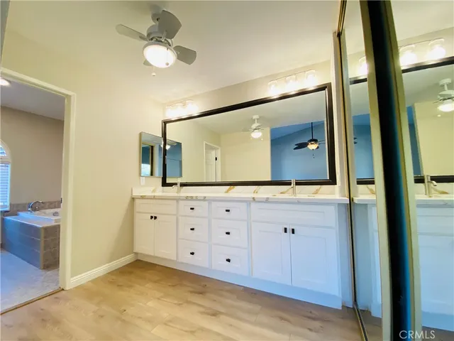 a bathroom with a double vanity sink and a mirror