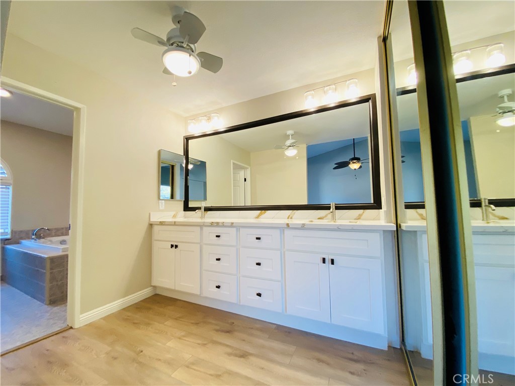 30 Mountain Shadows Place Pomona, CA 91766 - Photo 20 of 23 a bathroom with a double vanity sink and a mirror
