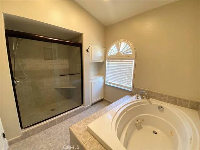 a bathroom with a bathtub and a shower