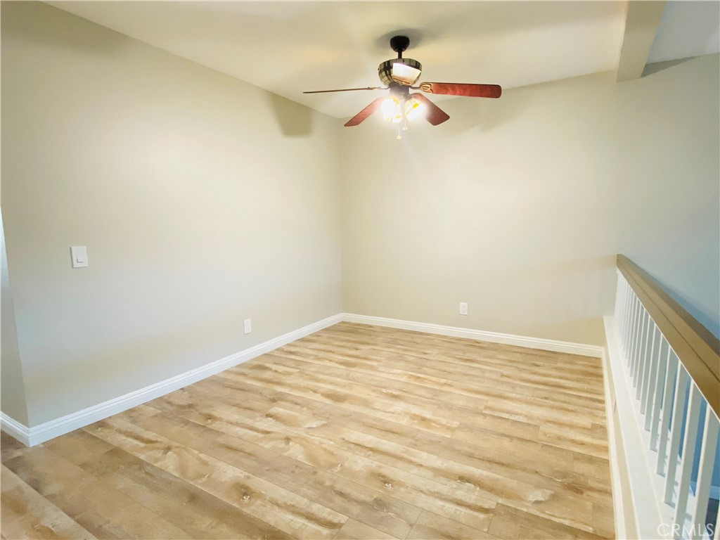 30 Mountain Shadows Place Pomona, CA 91766 - Photo 4 of 23 a view of a room with a ceiling fan and wooden floor