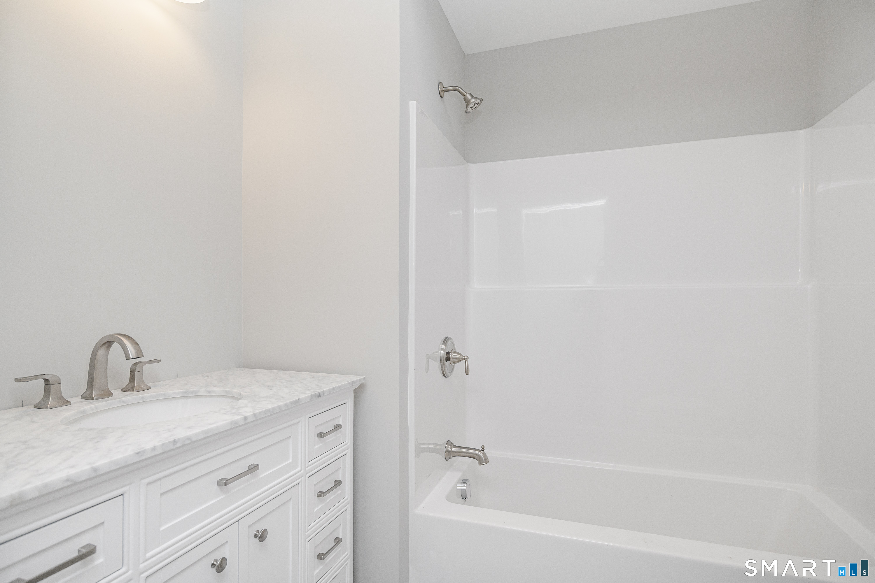 284 Chestnut Tree Hill Road Oxford, CT 06478 - Photo 19 of 34 a bathroom with a granite countertop sink a mirror and a bathtub