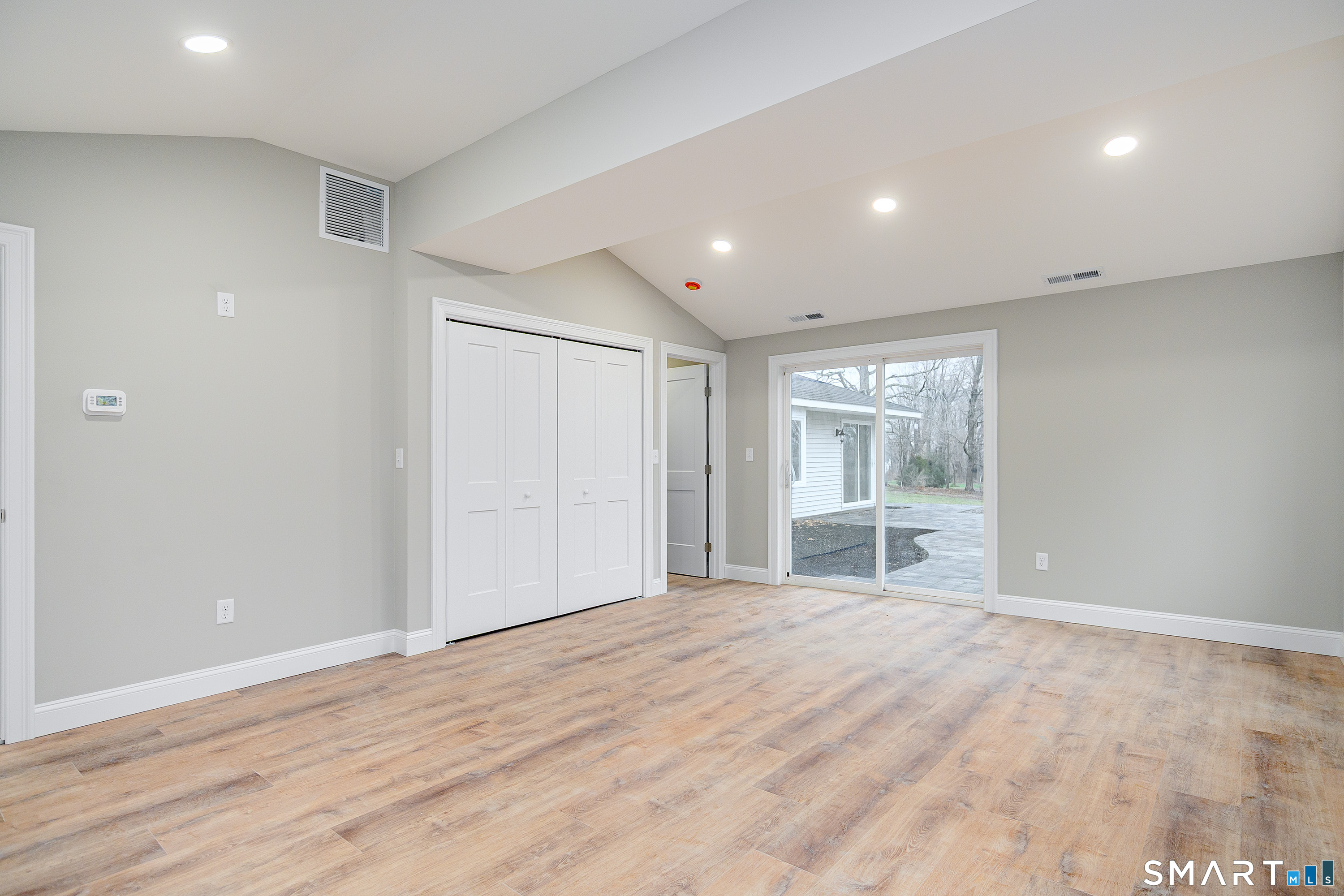 284 Chestnut Tree Hill Road Oxford, CT 06478 - Photo 21 of 34 a view of an empty room with wooden floor and a window
