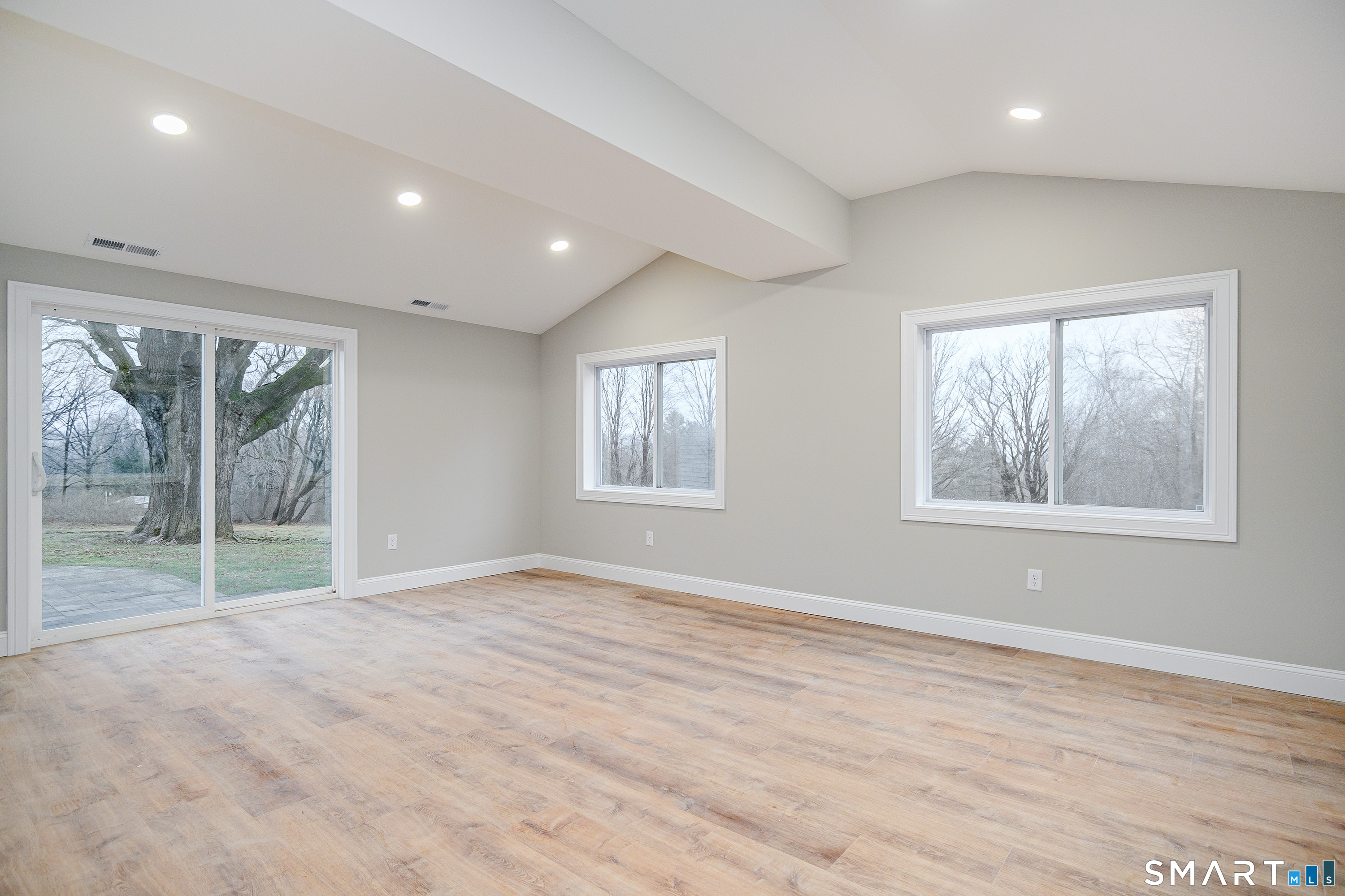 284 Chestnut Tree Hill Road Oxford, CT 06478 - Photo 22 of 34 a view of an empty room with wooden floor and a window