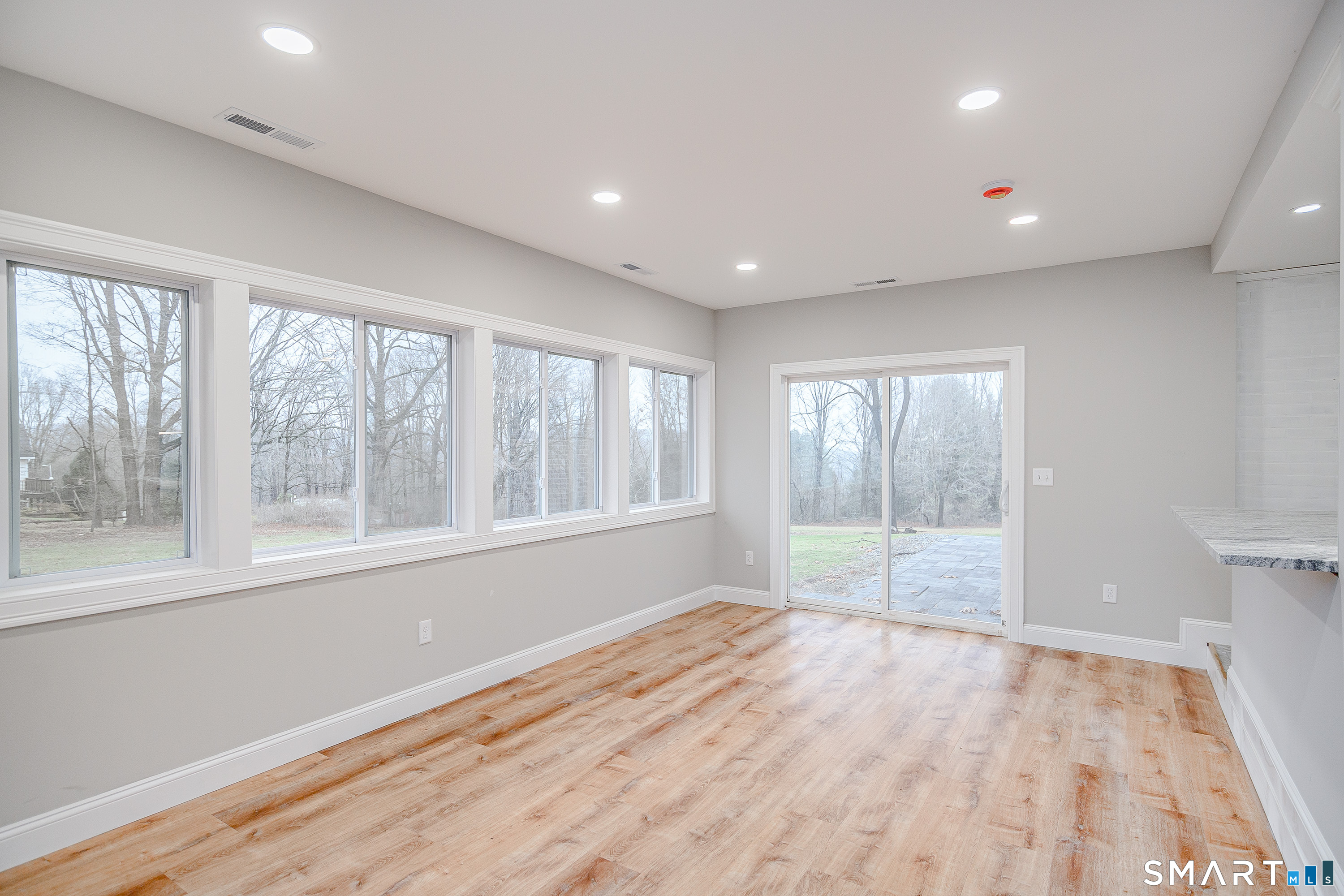 284 Chestnut Tree Hill Road Oxford, CT 06478 - Photo 6 of 34 a view of empty room with wooden floor and fan