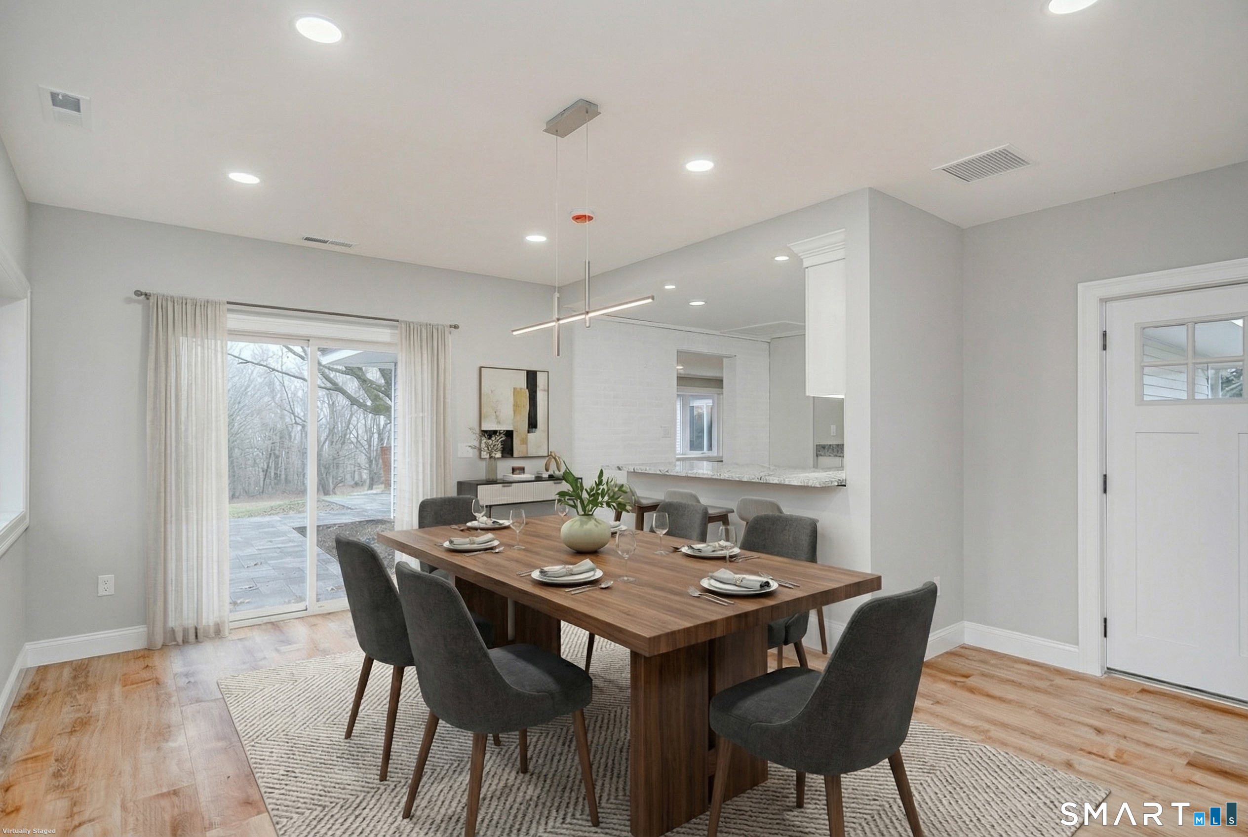 284 Chestnut Tree Hill Road Oxford, CT 06478 - Photo 9 of 34 a view of a dining room and livingroom with furniture wooden floor a rug a potted plant and a painting