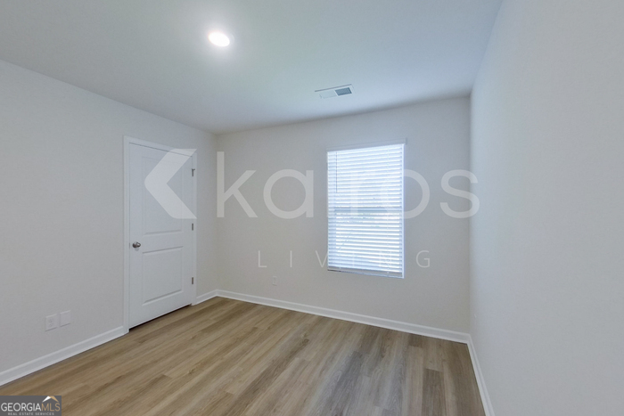 109 Inez Avenue Springfield, GA 31329 - Photo 15 of 26 an empty room with wooden floor and windows