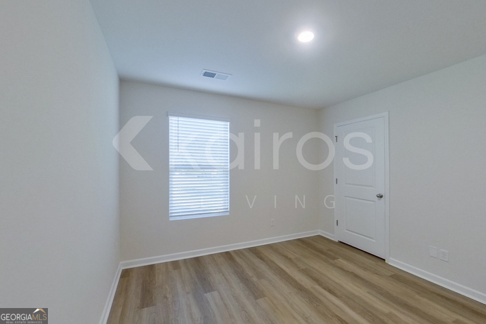 109 Inez Avenue Springfield, GA 31329 - Photo 17 of 26 an empty room with wooden floor and windows