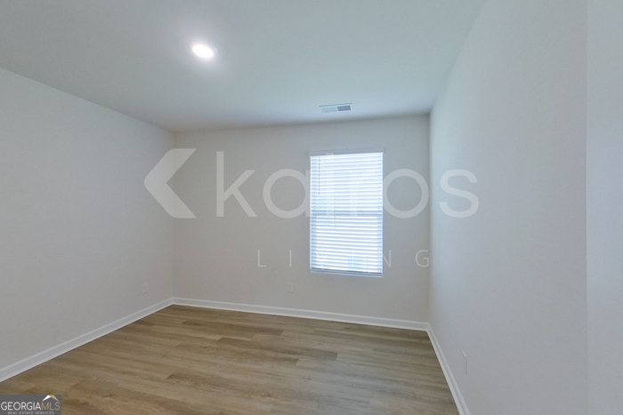 109 Inez Avenue Springfield, GA 31329 - Photo 19 of 26 a view of an empty room with wooden floor and window