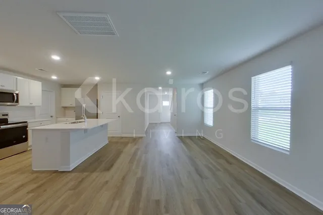 a view of room with window and wooden floor