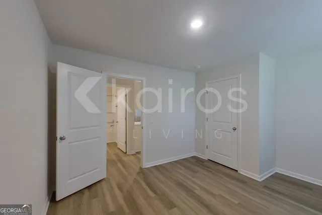 a view of a room with wooden floor and white walls