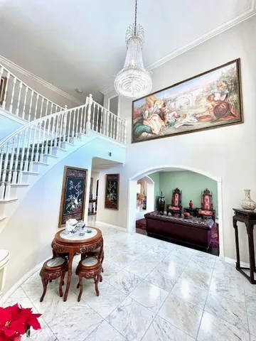 a living room with furniture and a chandelier
