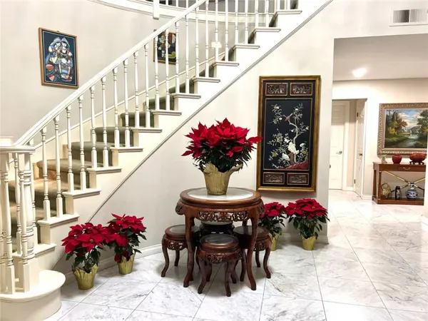 a view of a dining room with furniture and a chandelier