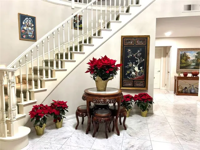 a view of a dining room with furniture and a chandelier