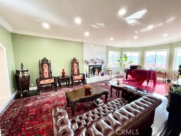 a living room with furniture a rug and a flat screen tv