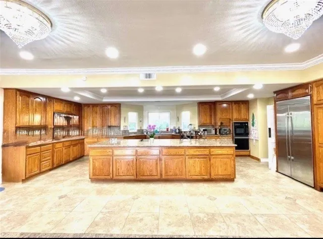 a large kitchen with granite countertop lots of counter top space