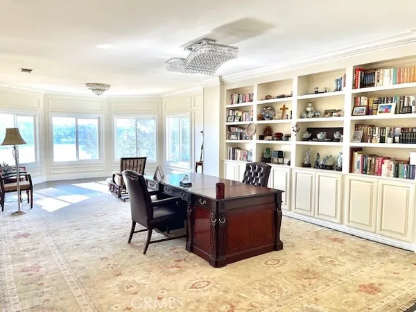 a living room with furniture and a book shelf