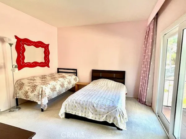 a bedroom with two beds and lamp