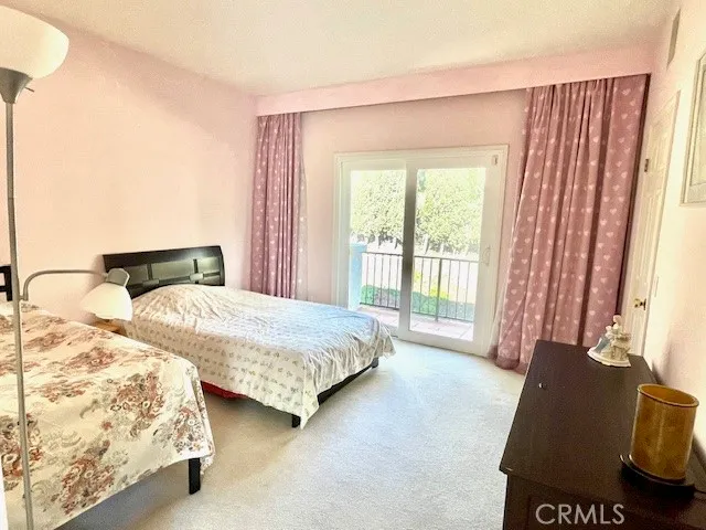 a bedroom with two beds and large window