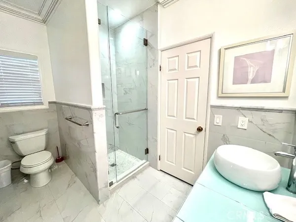 a bathroom with a toilet sink and a shower