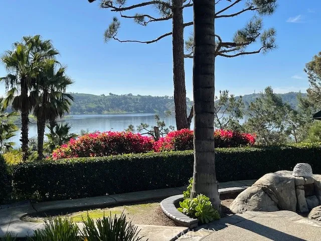 a view of a fountain in front of a house and a yard