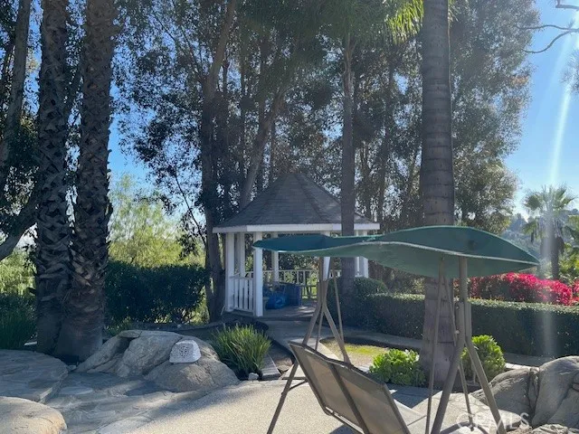 a front view of house with outdoor seating and green space