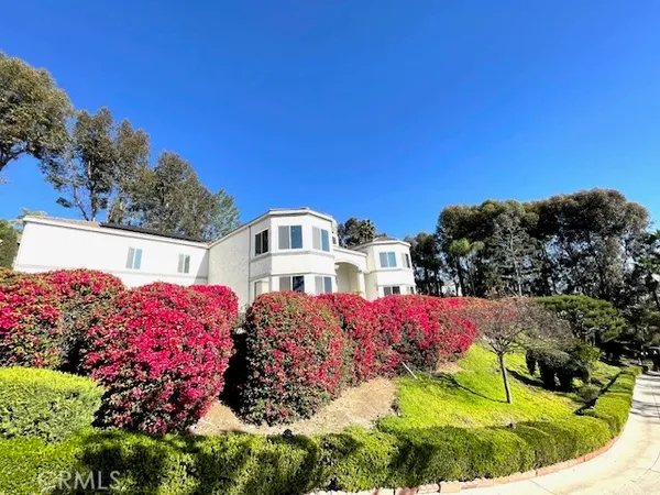 a view of a house with a yard and garden