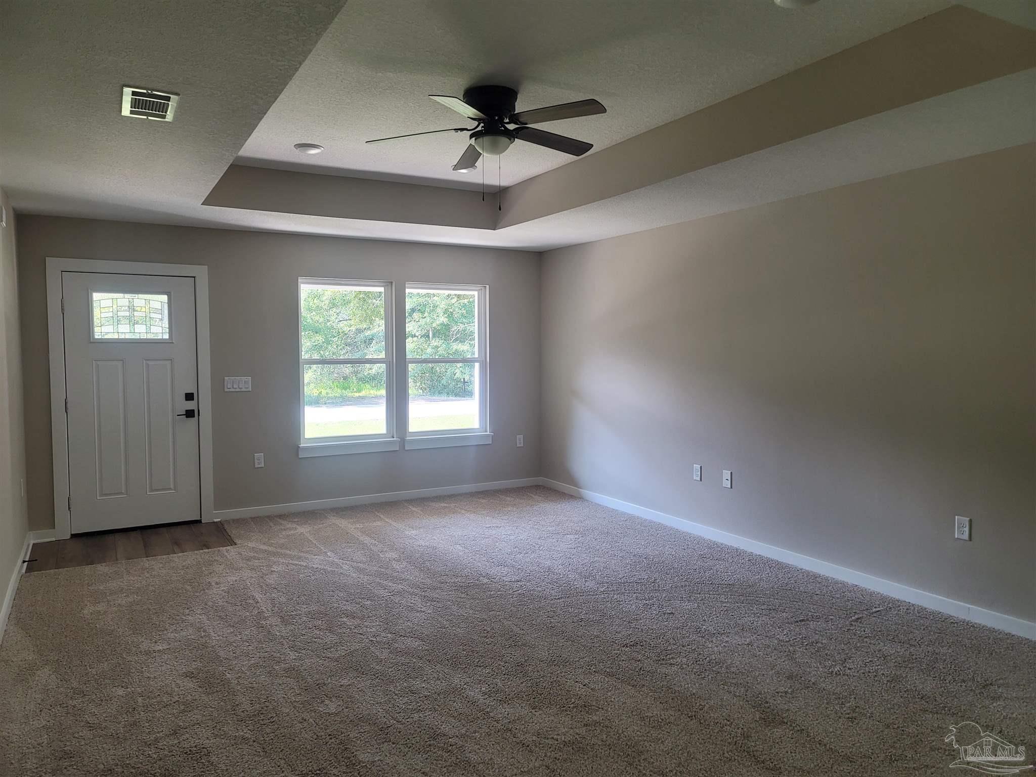 3030 Ferris Drive Navarre, FL 32566 - Photo 13 of 40 an empty room with a ceiling fan and window