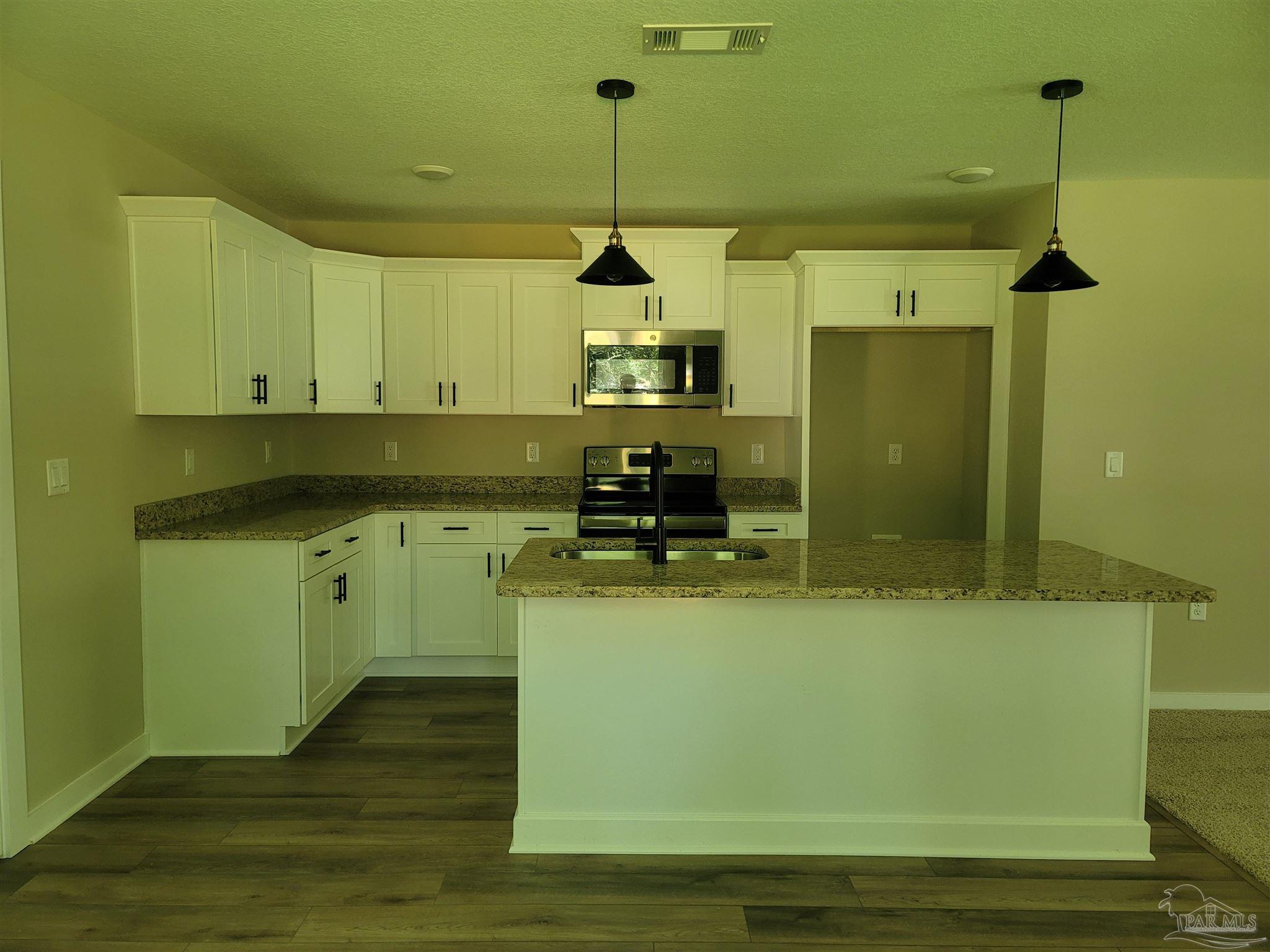 3030 Ferris Drive Navarre, FL 32566 - Photo 17 of 40 a kitchen with sink and cabinets