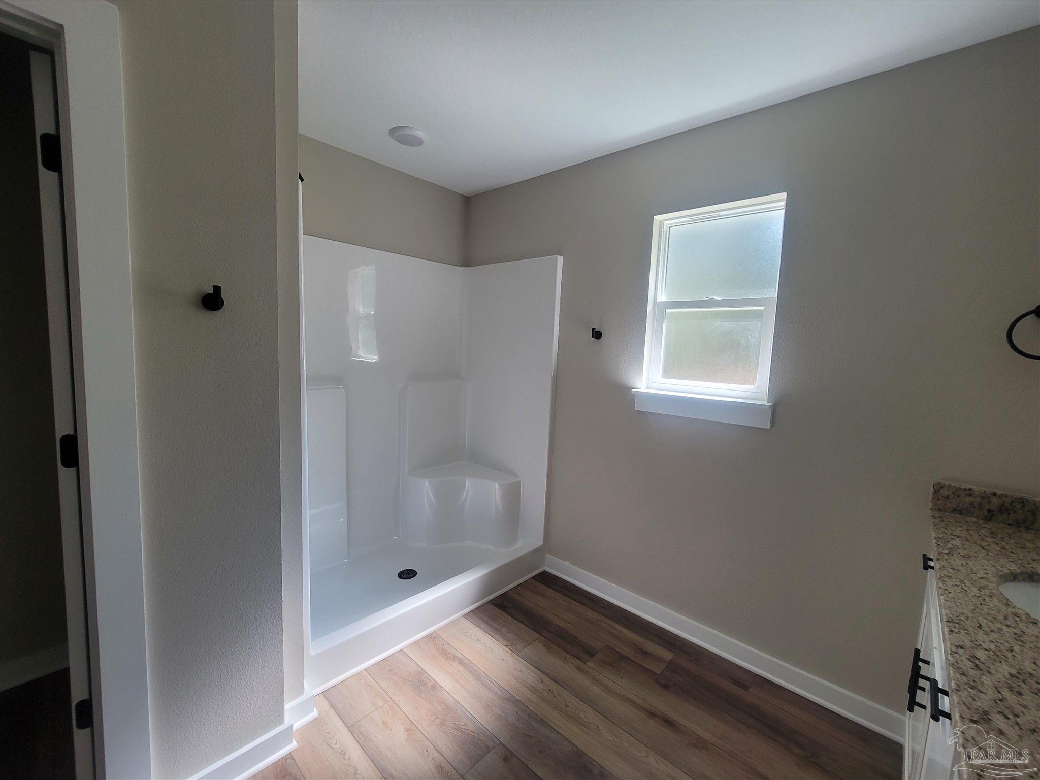 3030 Ferris Drive Navarre, FL 32566 - Photo 34 of 40 a bathroom with a shower and a window