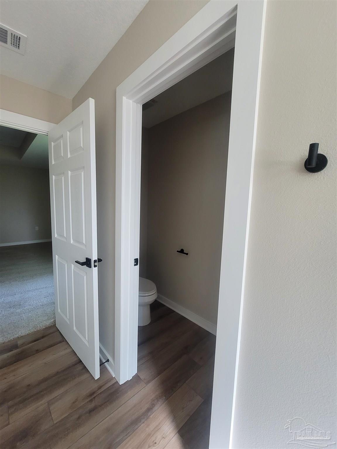 3030 Ferris Drive Navarre, FL 32566 - Photo 36 of 40 a view of a hallway with wooden floor