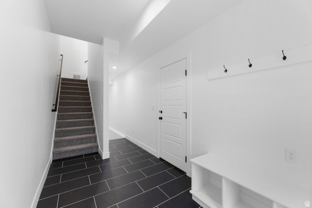 14392 South Champ Cove Draper, UT 84020 - Photo 29 of 31 Mudroom with baseboards and dark tile patterned flooring